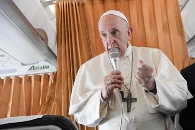 On papal flight, Pope Francis tackles debate over Communion for politicians who support abortion