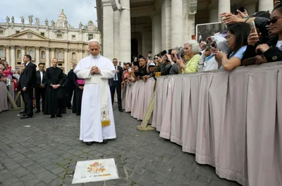 Pope Leo XIV prays at the spot where St. John Paul II was shot