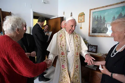 Pope goes door to door, blessing the homes of the poor
