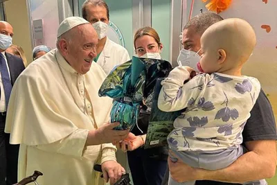 Pope Francis visits pediatric oncology ward at hospital, baptizes newborn baby
