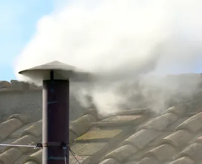 White smoke puffs out of Sistine Chapel chimney, signaling election of new pope