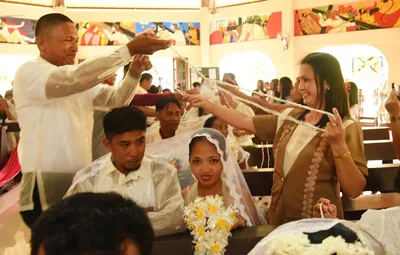 22 couples tie the knot amid bombings