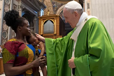 Migrants are people, not just a social issue, pope says at Mass