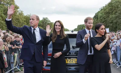 Harry and Meghan unexpectedly join William and Kate to greet crowds paying tribute to Queen Elizabeth II