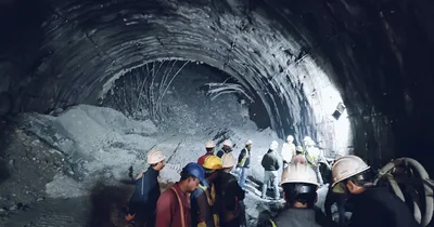 Rescuers dig for workers trapped in collapsed tunnel in India