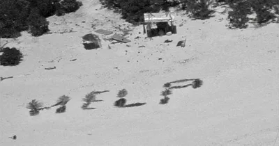 Castaways rescued from writing ‘help’ on island beach