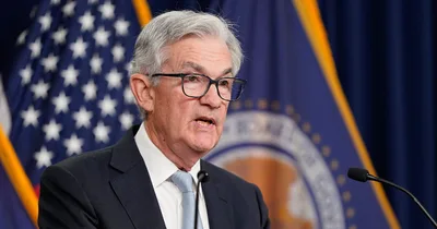 Fed raises interest rates, hints at pullback