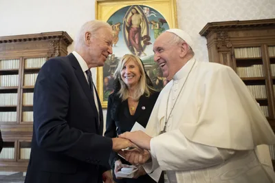 President Joe Biden receives Communion at Mass in Rome
