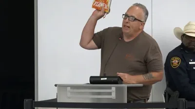 Texas school board forcibly removes protester who slammed library book for 'homosexuality and satanism'