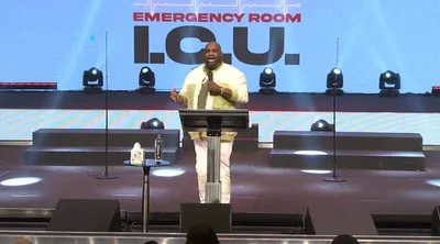 Pastor John Gray praises God as he leaves hospital after health scare