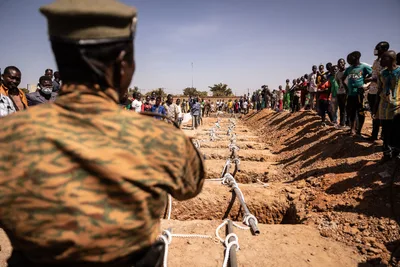 At least 100 killed in Burkina Faso massacre as militants go 'shop to shop' killing men