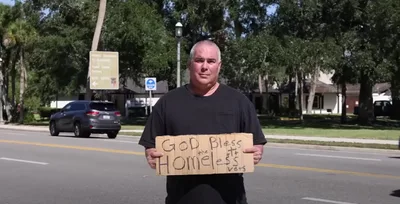 Man arrested for holding ‘God bless the homeless vets’ sign sues city
