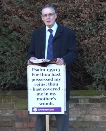 Preacher facing prison for holding Bible verse sign near abortion clinic