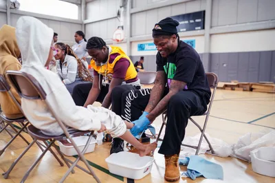 Baltimore Ravens Players Wash Local Students’ Feet and Give Them New Shoes, Led By Team Chaplain - RELEVANT