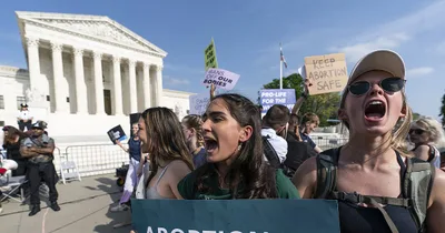 Protesters keep watch outside the Supreme Court
