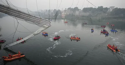 Nine Arrested after Bridge Collapse in India Kills 134